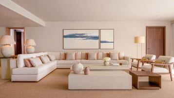 A modern living room with a sectional sofa, a coffee table, and two floor lamps.