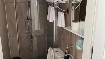 Shower, hair dryer, slippers, towels