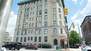 A multi-story building with a classic architectural style, featuring a flat roof and symmetrical windows. - Stylish Top Floor Condo in Downtown Indianapolis, Mile Square Neighborhood  (Indianapolis)