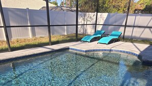 A clear swimming pool with a tiled edge and a white fence in the background. - Brand new house with heated salt water pool. Perfect get away in Palm Coast (Palm Coast)