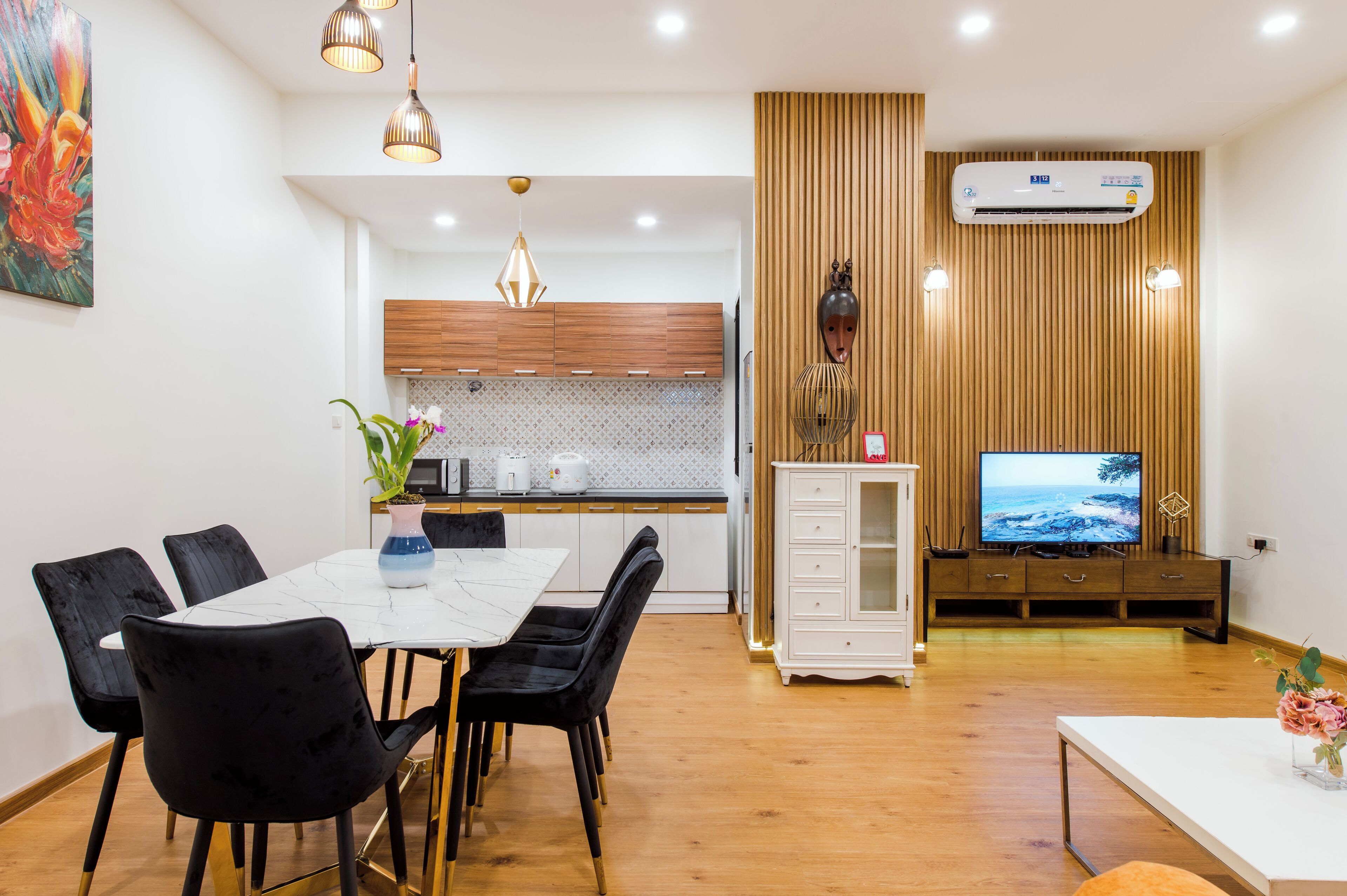 A modern kitchen with wooden cabinets, a white countertop, and a built-in oven.