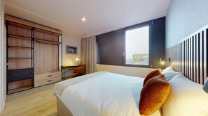 Apartment, 1 Bedroom, City View | Desk, laptop workspace, blackout drapes, soundproofing