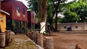 A rustic building with a cobblestone path leading to a wooden door.