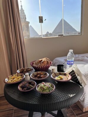 Enjoy meals with a view of the pyramids from this dining table.