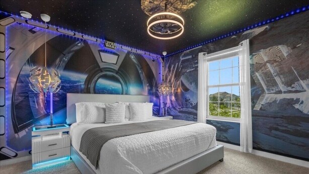 A bedroom with a large bed, a nightstand, and a wall mural. - EV_9026 - 6 Bed 6 Bath Home with Screened-In Private Pool with Spillover Spa and (Davenport)