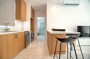 Enjoy cooking in this well-equipped kitchen with a dishwasher and island seating area.