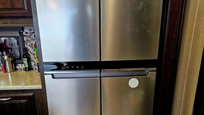 A stainless steel refrigerator with a digital display, a freezer compartment, and a control panel with multiple buttons. - Cozy RV with WiFi and HVAC in Glendale/North Phoenix Luxury Fifth wheel camper (Glendale)