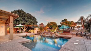 A pool area with a stone deck, lounge chairs, and umbrellas. - Mesa Lake Front House With Pool and Hot Tub! (Mesa)