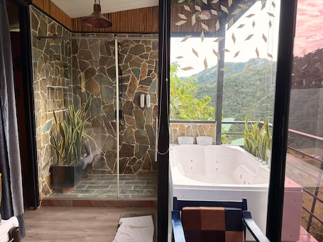 Separate bathtub and shower, towels, soap, shampoo. Magma Ecohotel