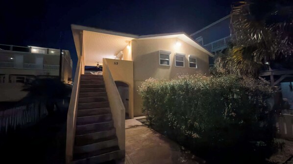 A small, single-story building with a staircase leading to an entrance.