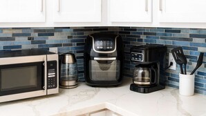 A kitchen with a microwave, coffee maker, and coffee pot. - Near Beach " Updated " Pool & Hot Tub (South Padre Island)