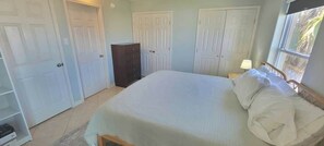 A bedroom with a bed, a dresser, and a wardrobe. - * Pool  * 2 Levels * 2 Patios * Near Beach (South Padre Island)