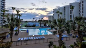 A hotel pool area with a large pool, sun loungers, and palm trees. - * Gas BBQ * Heated Pool * Direct Beach  Very Large (South Padre Island)