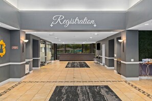 A registration area with a reception desk, a black and white patterned rug, and a sign above the desk. - WorldMark Indio - 2 Bedroom/2 Bath Condo for Coachella, sleeps 6 (Indio)
