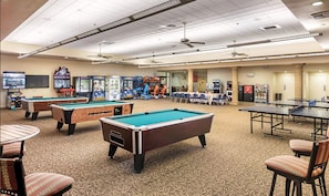 A recreational area with pool tables, arcade games, and seating. - WorldMark Indio, 2 Bedroom/2 Bath Condo for Coachella (Indio)