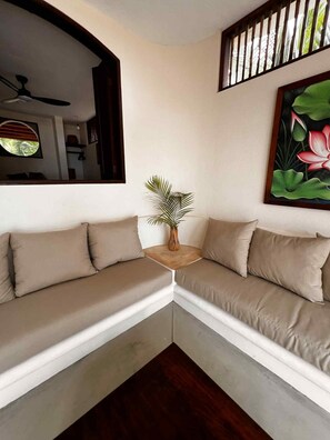 A corner seating area with a sofa and a small table with a plant. - Quaint 3-bedroom house with WiFi in Troncones (Troncones)
