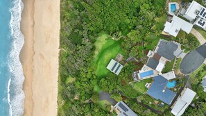 Enjoy a beachfront setting surrounded by lush gardens and a swimming pool.