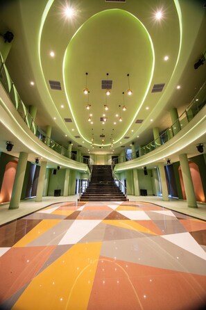 A spacious interior with a central staircase, green walls, and a patterned floor. - The Sky Imperial Jodhpur (Jodhpur)
