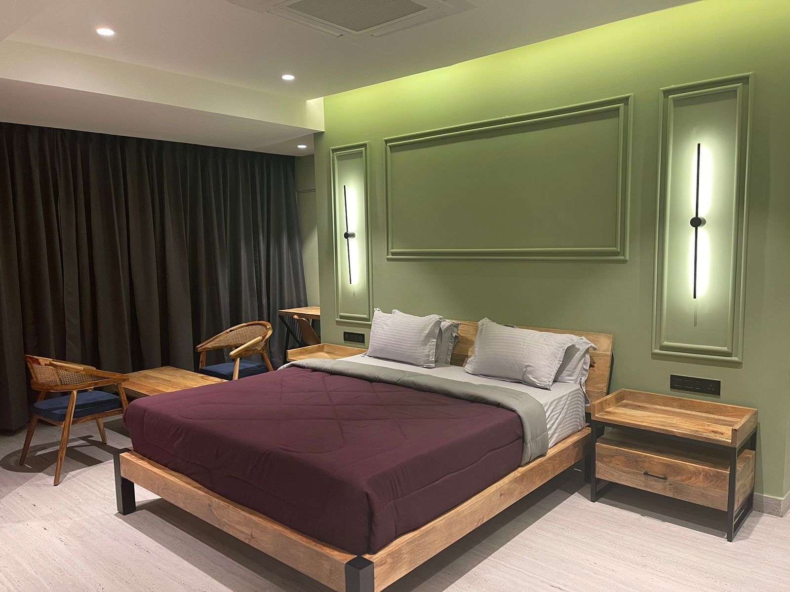 A modern bedroom with a wooden bed, a desk, and a chair.