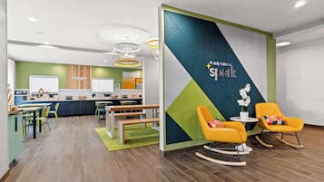 Relax and work in style with a comfortable seating area, kitchen amenities, and a unique reception sign.