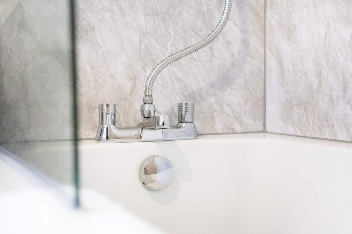 A bathroom with a shower, a bathtub, and a glass-enclosed shower area.