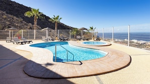 A pool area with lounge chairs and a view of the sea. - Home2Book Costa Adeje Escape & Pool, Only Adults (Adeje)