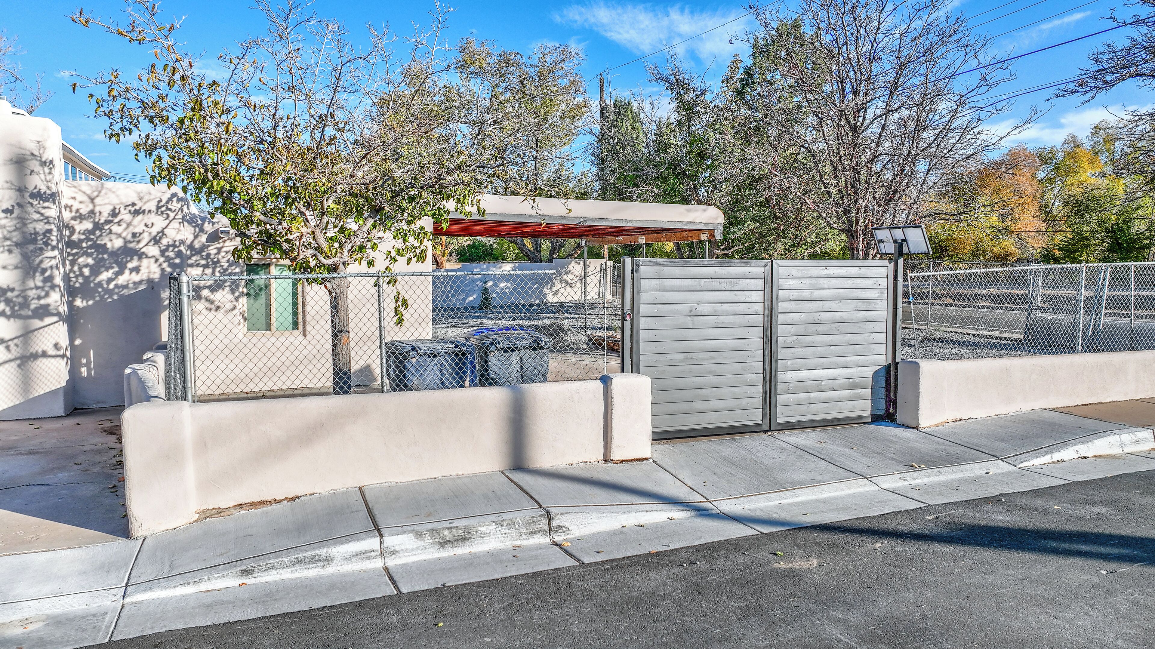 Remote controlled gates to the covered parking area.