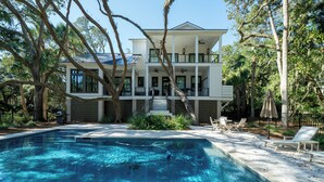A two-story house with a swimming pool, outdoor seating, and a covered patio. - 4 Bed/3.5 Bath! Pool! Amenity access included! Golf Course Views! (Seabrook Island)