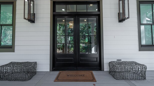 A black double door with a glass panel, a welcome mat, and two outdoor seating areas. - 4 Bed/3.5 Bath! Pool! Amenity access included! Golf Course Views! (Seabrook Island)