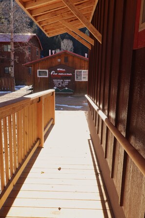 Step out onto the deck and enjoy the serene surroundings of The Cabin Lodge, where lake fireplaces and individual cabins await.