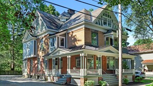 A two-story house with a front porch, a garage, and a driveway.