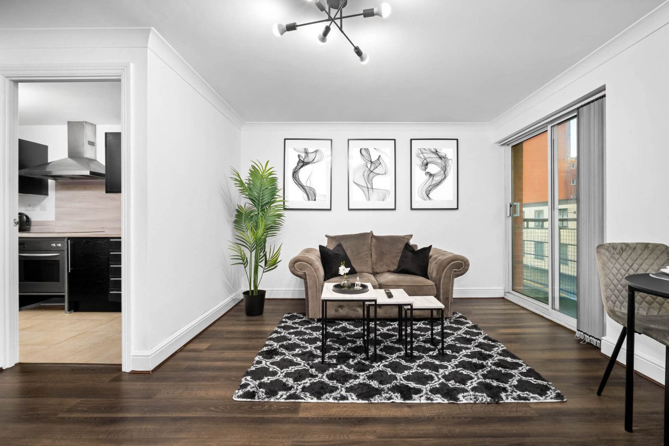 A modern living room with a sofa, coffee table, and artwork on the wall.