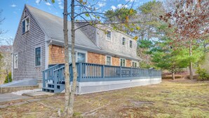 A two-story house with a wooden exterior, a blue porch, and a small front yard. - Great for Families! Brewster Home 6 Mi to Beach (Brewster)