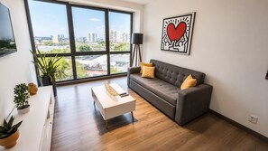 A modern living room with a sofa, coffee table, and potted plants. - Luxury Escape Indoor Pool, Gym, High Speed WiFi (Ciudad de México)