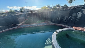 A swimming pool with a tiled edge, surrounded by a fence and a brick border. - Relax @ Retreat Pool Hot Tub Billiards Game SF Bay (Santa Clara)