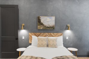 A bedroom with a bed, two bedside tables, a headboard, and a painting on the wall. - Our Place; Our Home has an inside slide, gourmet kitchen, view for days, and just feels like home! (Hurricane)