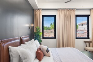 A bedroom with a bed, curtains, a plant, and a view of the outside. - Our Place; Our Home has an inside slide, gourmet kitchen, view for days, and just feels like home! (Hurricane)