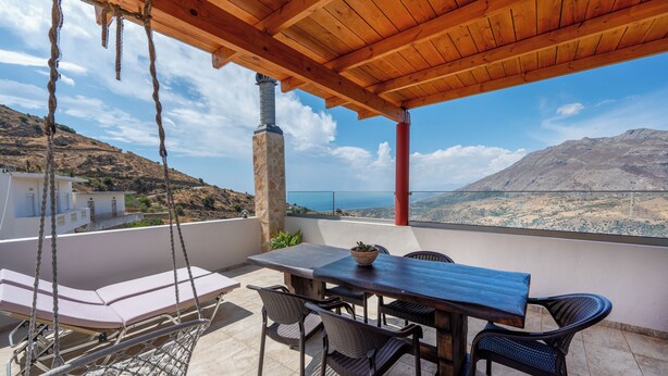 A wooden pergola with a table and chairs, overlooking a scenic view of a mountainous landscape and the sea. - Private Pool, Sunny Location, South Rethimno, Ideal for Adults (Saktouria)
