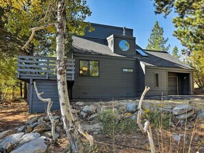 A modern house with a sloped roof, a visible chimney, and a small deck area. - Dwell at Tahoe Donner by Tahoe Getaways - 3BR w Private Sauna + HOA Amenities! (Truckee)
