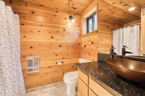 A wooden cabin bathroom with a wooden toilet, a large vessel sink, and a window above the sink. - Dwell at Tahoe Donner by Tahoe Getaways - 3BR w Private Sauna + HOA Amenities! (Truckee)