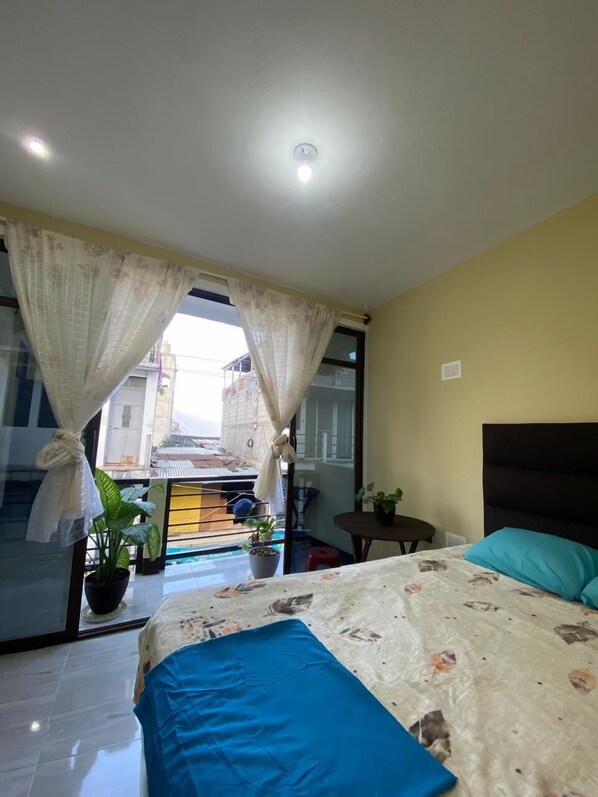 Relax in this stylish room with a large bed, dark headboard, and modern design.
