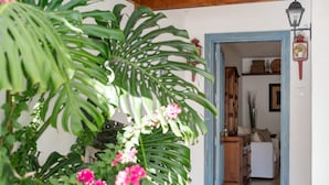 A doorway leading to a room with a wooden cabinet and a white sofa. - Holiday Home 'Casa Princesa Guayarmina 49' with Private Terrace, Garden & Wi-Fi (Puerto del Carmen)