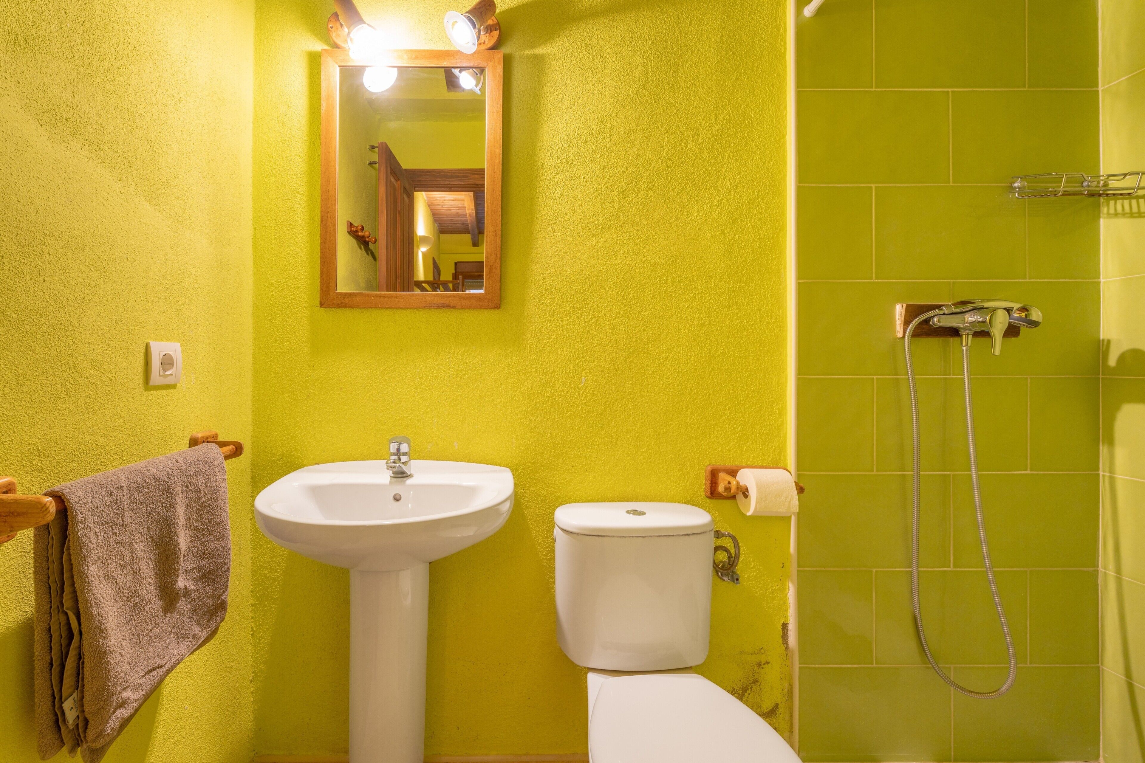 A bathroom with a sink, toilet, and shower.