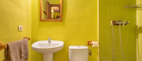 A bathroom with a sink, toilet, and shower.