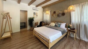 A bedroom with a wooden bed, a standing lamp, a potted plant, and a wall-mounted air conditioner. - Fabulous 3-bedroom Private Villa in Lubao Pampanga with plunge pool (Lubao Pampanga)