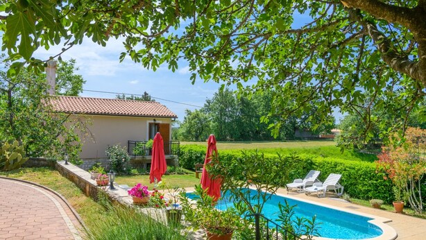 A pool area with lounge chairs and a house in the background. - Villa Martina (Istria - Labin) (Šumber)