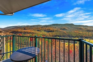 A balcony with a view of autumnal hills and a clear sky. - Sleeps 6 Mountain Views Shared Resort Amenities (Gatlinburg)