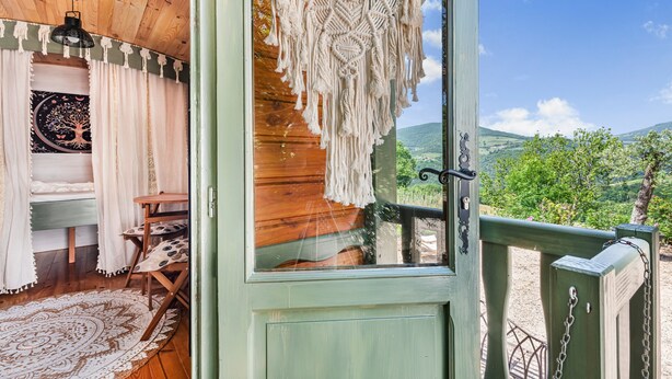 A wooden cabin with a view of a mountainous landscape. - Spacious, Bright and Welcoming Gîte with Mountain View, Private Terrace and Air Conditioning (Beaujeu)