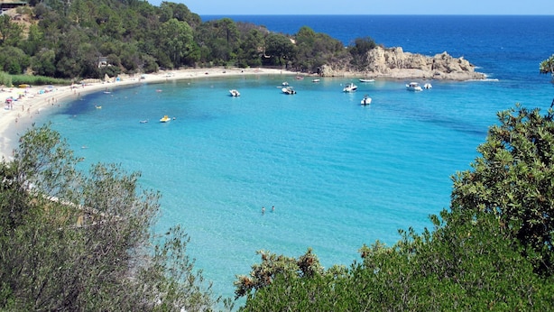 A coastal beach with clear blue waters, boats, and a sandy shore. - T2 Gabriello by Interhome (Solenzara)