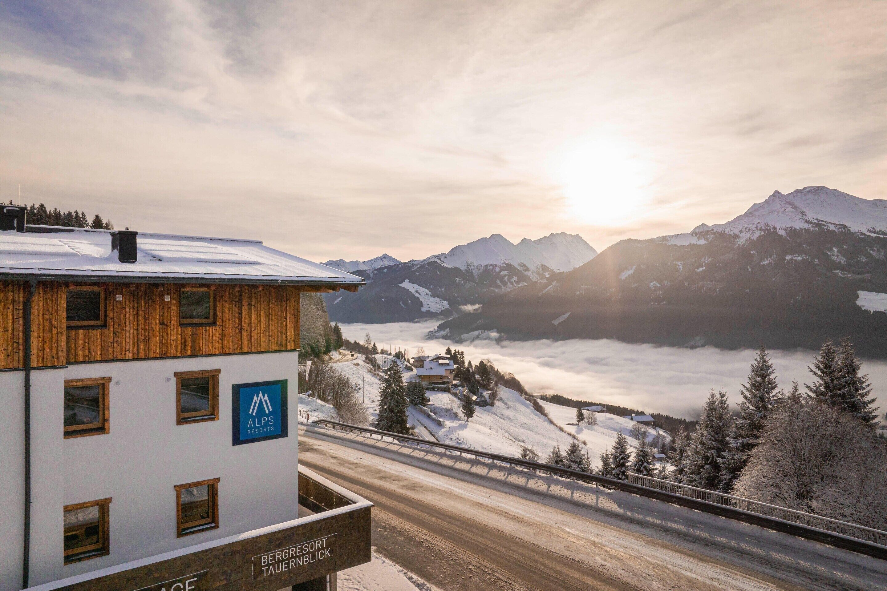 A building with a sign for 'Alps Resorts' and 'Bergriesort Tauerblick'.